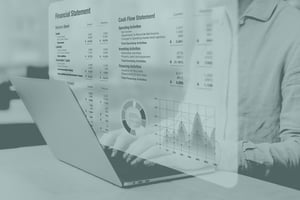 Green filter on laptop with financial information on the screen