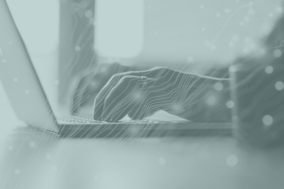 Hands using laptop with AI design overlayed