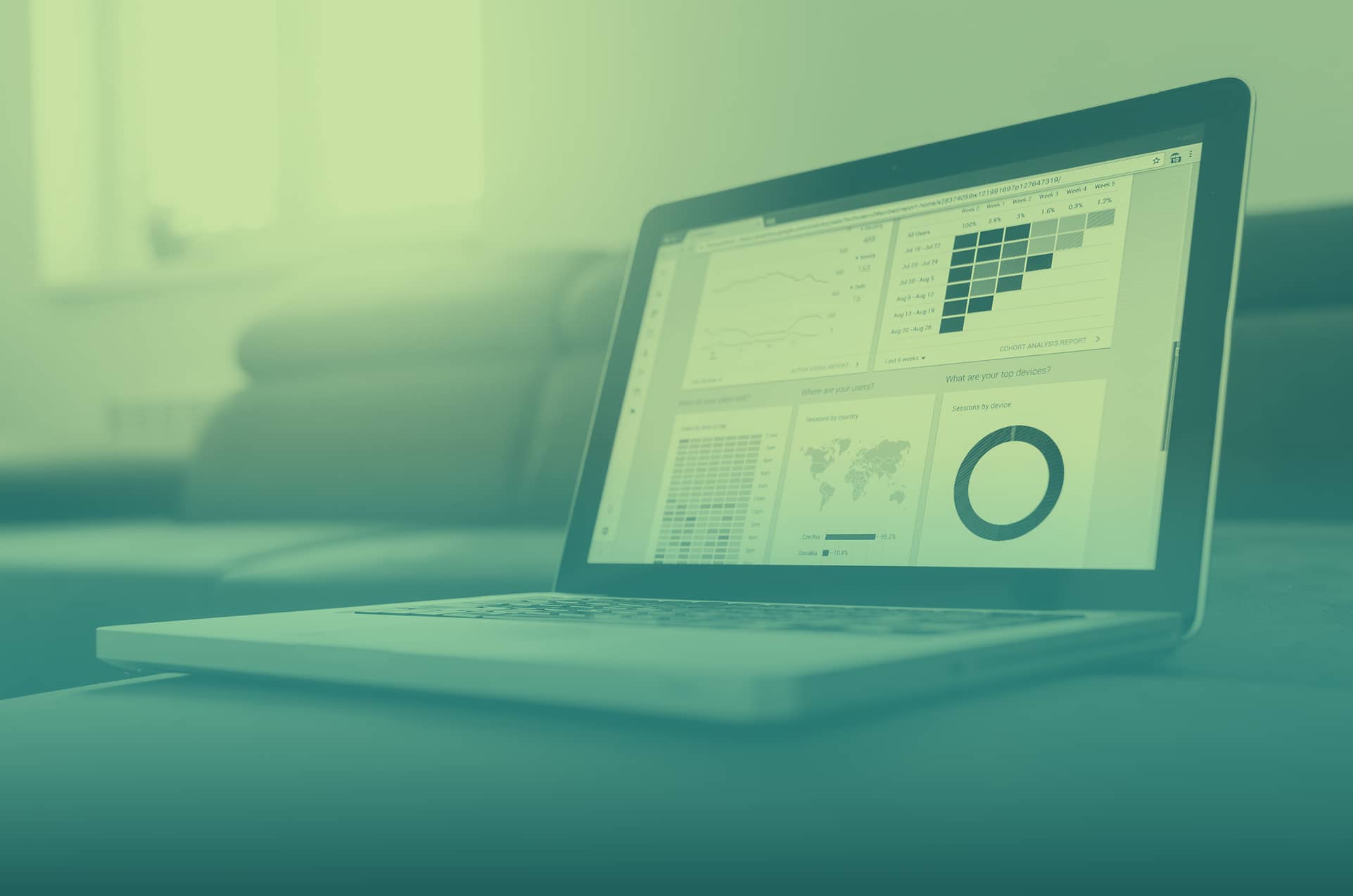 Duotone filter of laptop showing graphs and data